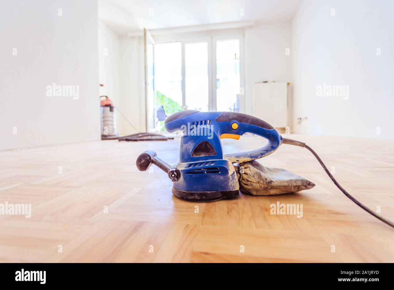 Close up of a sander power tool for DIY on wooden parquet floor Stock Photo