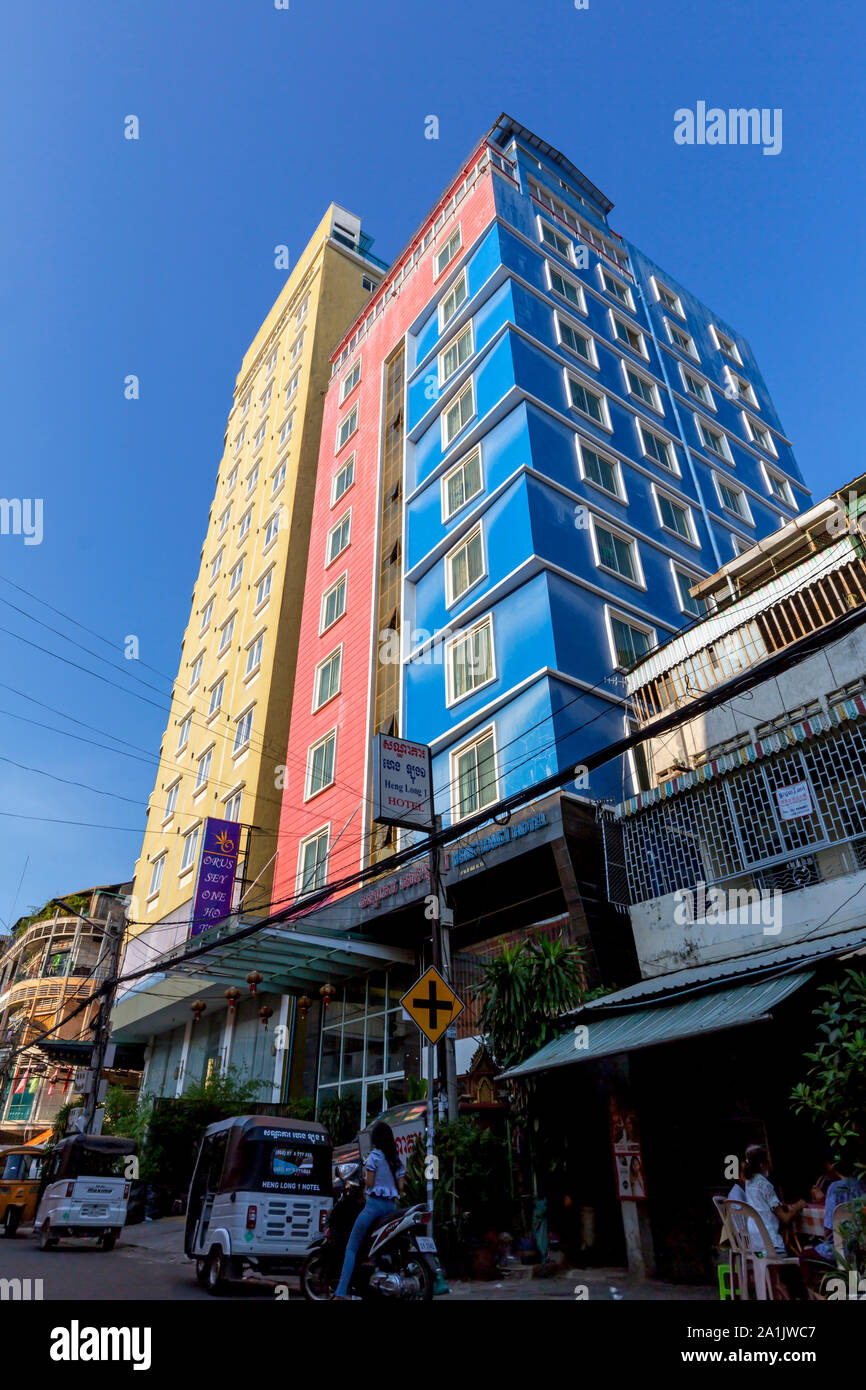 Tall and colorful buildings are part of the urban landscape above a city street in Phnom Penh, Cambodia. Stock Photo