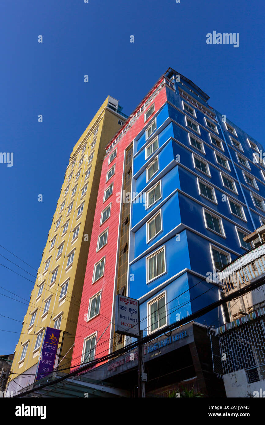 Tall and colorful buildings are part of the urban landscape above a city street in Phnom Penh, Cambodia. Stock Photo