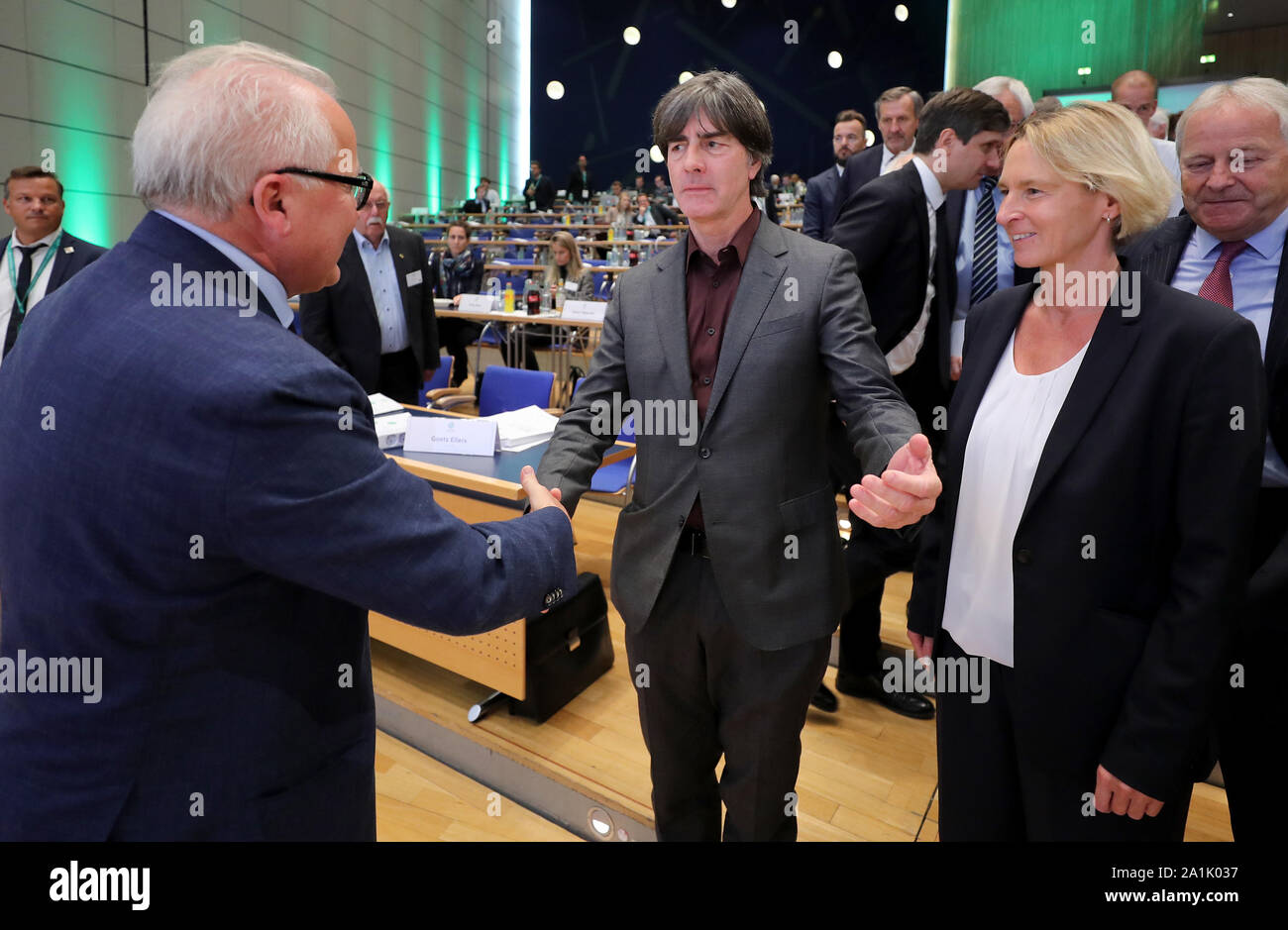HANDOUT - 27 September 2019, Hessen, Frankfurt/Main: Joachim Löw (M), national coach of the German men's national football team, and Martina Voss-Tecklenburg (r), national coach of the German women's national football team, congratulate the newly elected DFB President Fritz Keller (l) at the 43rd ordinary DFB Bundestag in the Congress Centre. The Bundestag of the German Football Association (DFB) is under the motto 'Bund für die Zukunft - Im Team den Fußball gestalten'. Photo: Simon Hofmann/Getty Images Europe/DFB/dpa - ATTENTION: Only for editorial use and only with complete mention of the ab Stock Photo