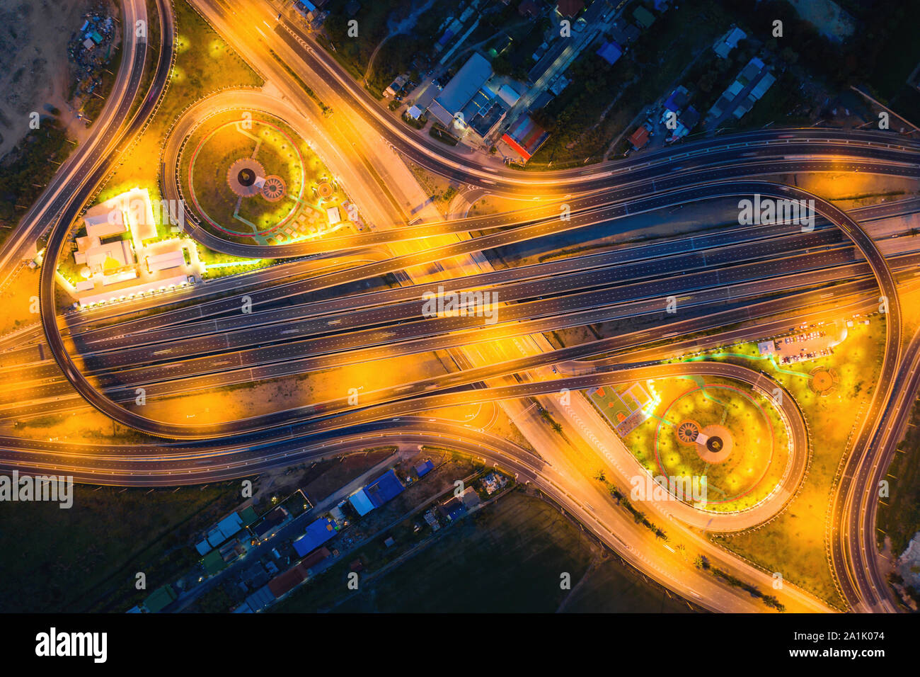 Aerial view of highway junctions Top view of Urban city, Bangkok at night, Thailand. Light trails across road junction, traffic abstract and transport Stock Photo
