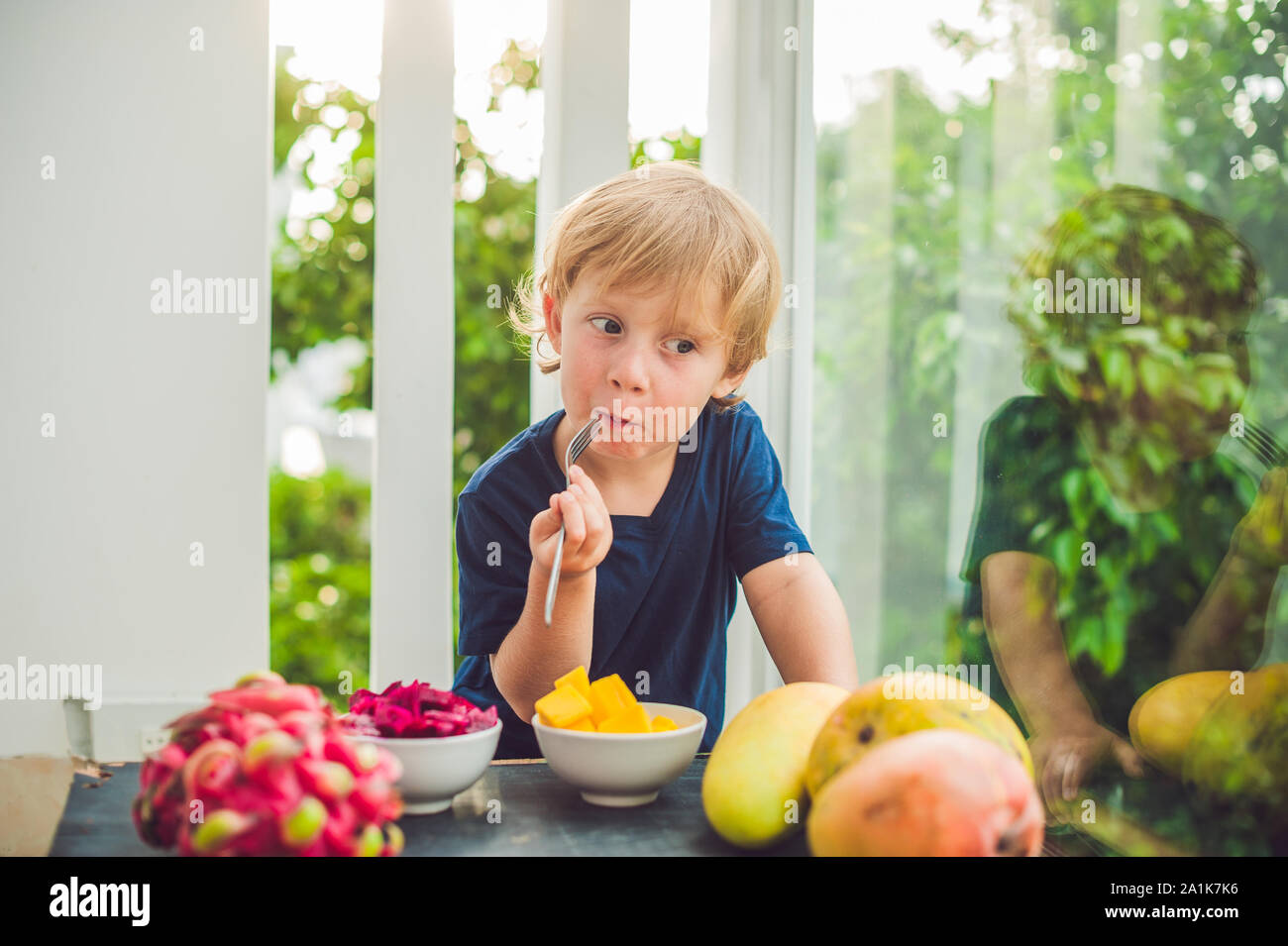 Baby eating mango hires stock photography and images Alamy