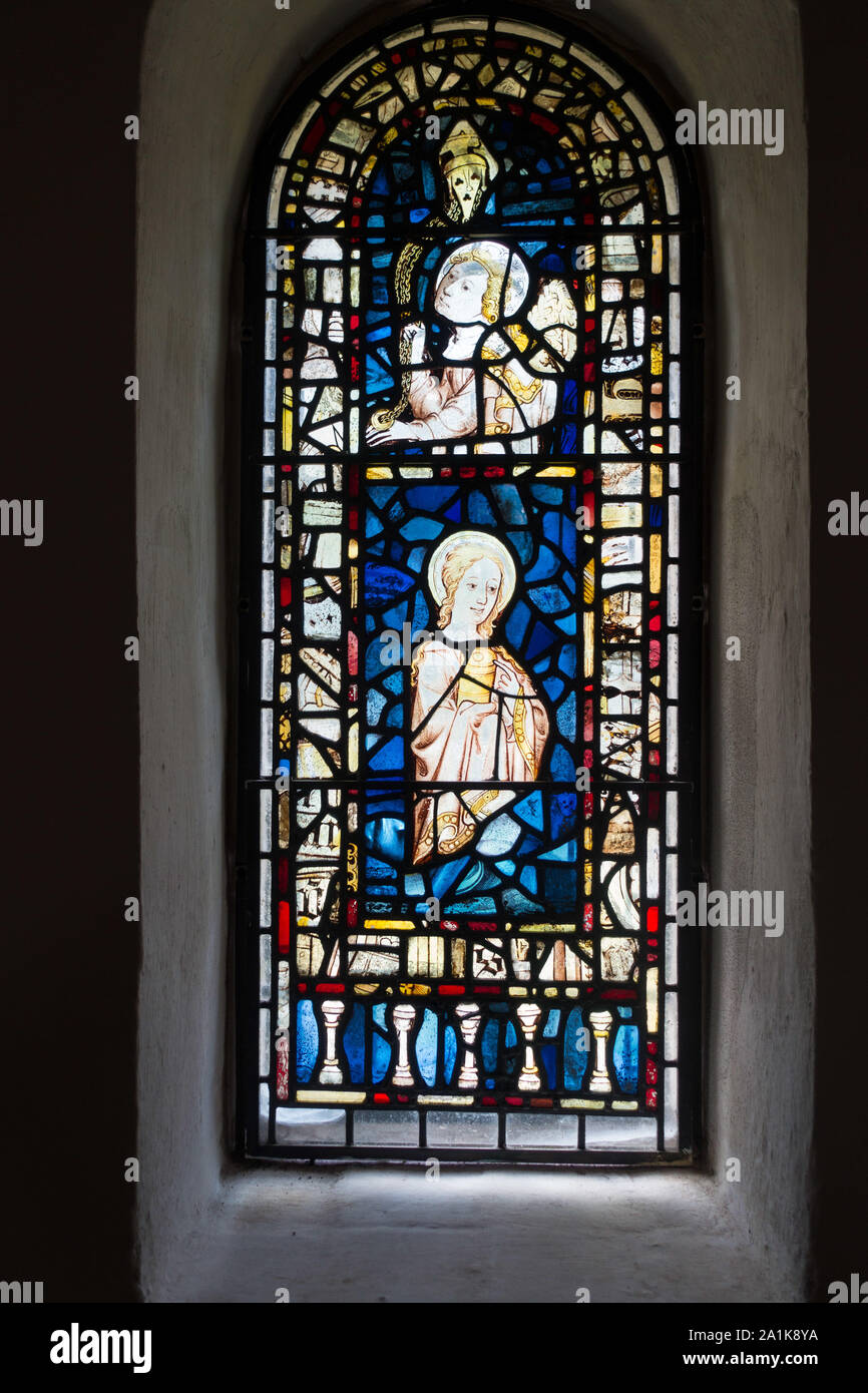 The west window of St Mary's Church, Burnham Deepdale, Norfolk with an angel and censer in the top frame and Mary Magdalene in the central frame. Stock Photo