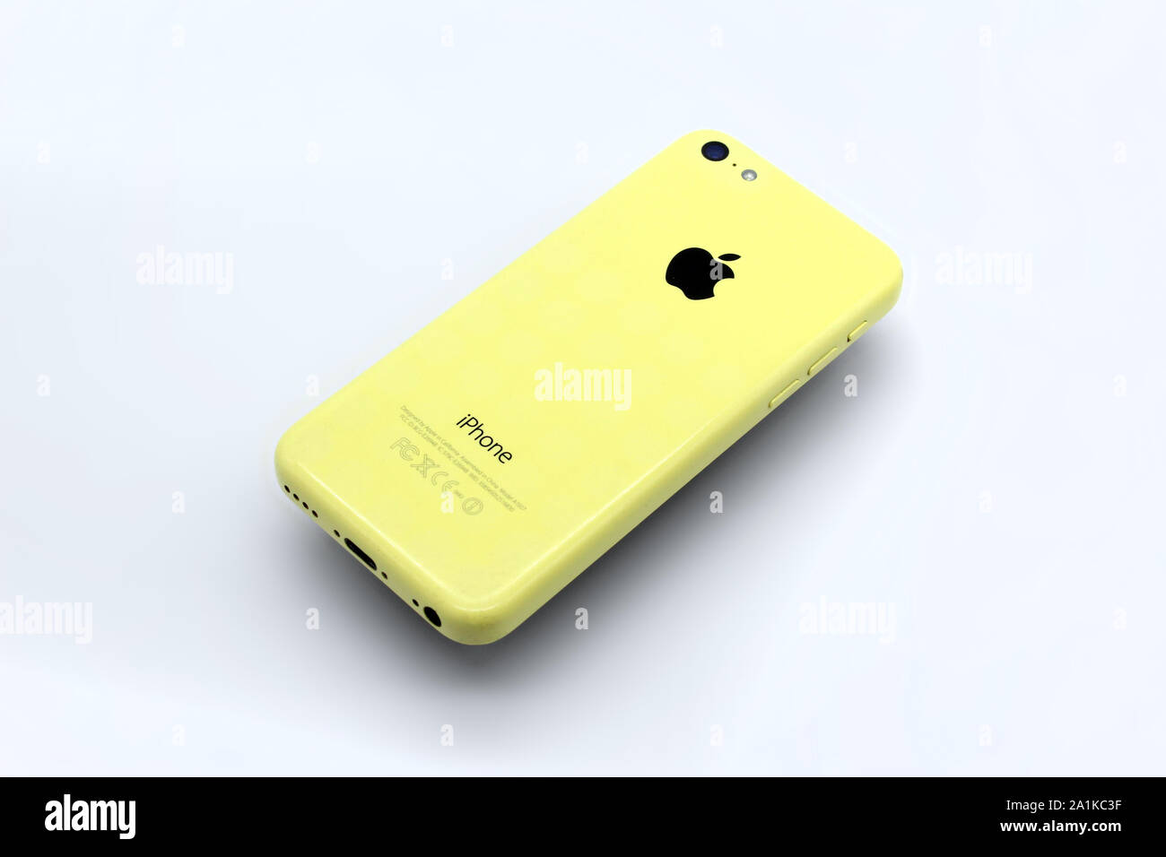Apple Iphone SE 5c smartphone yellow, isolated on white background, close-up Stock Photo