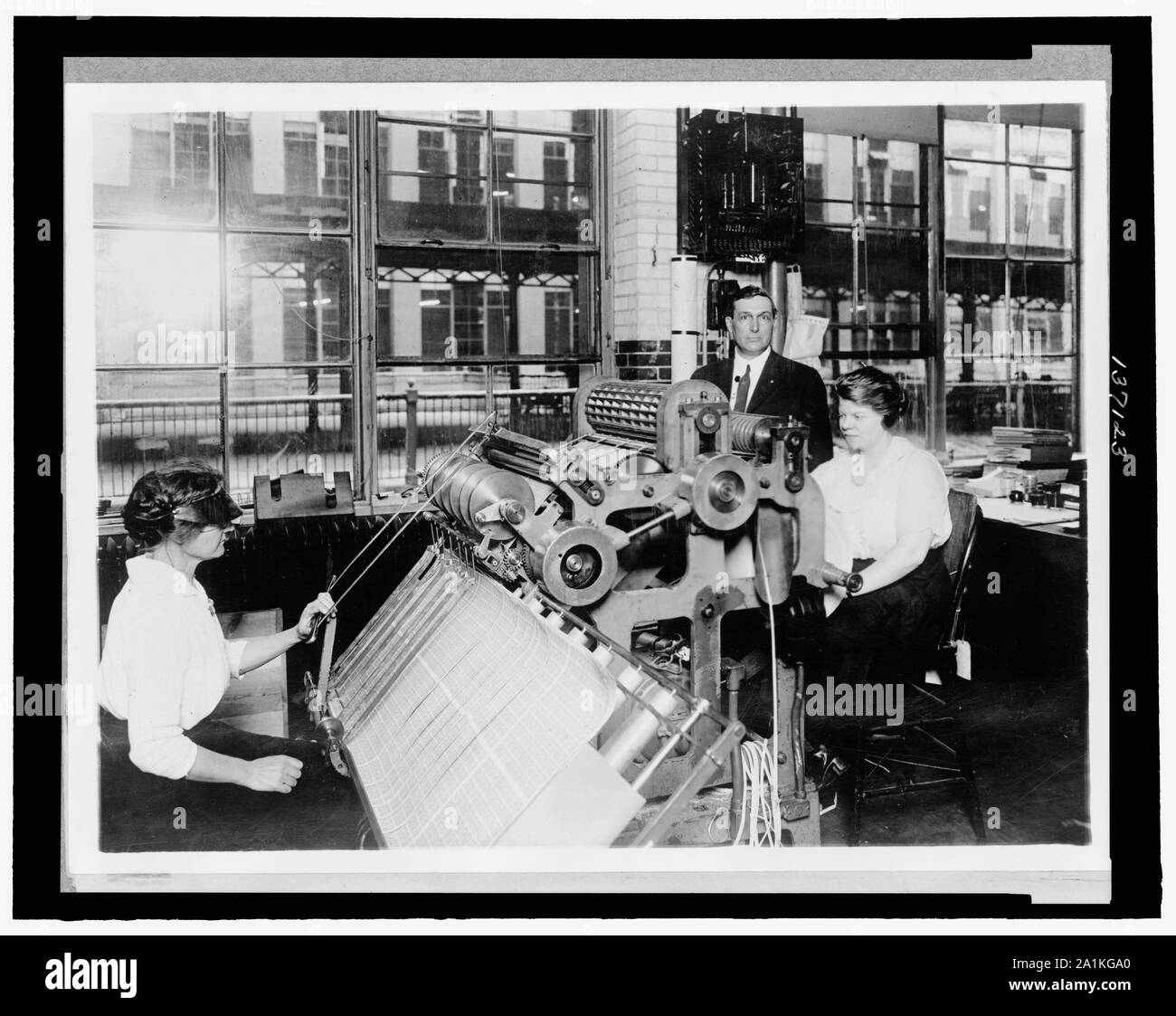New perforating machine used by the Bureau of Engraving and Printing for perforating postage stamps ... / National Photo. Stock Photo