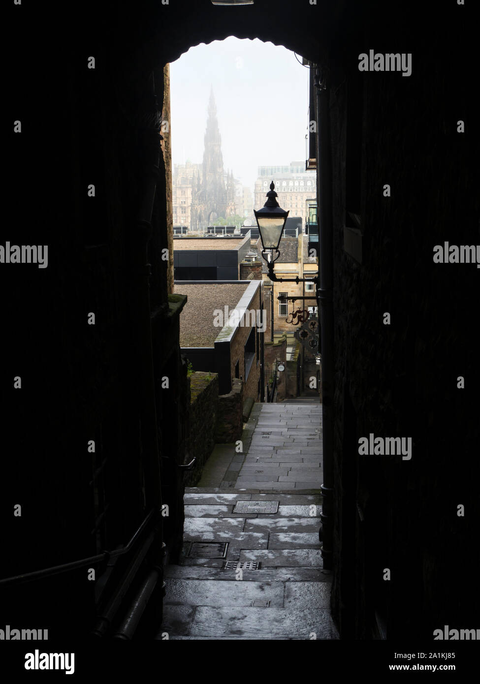 Hazy morning view of the Scott Monument through Advocates Close from the Royal Mile Edinburgh Scotland Stock Photo