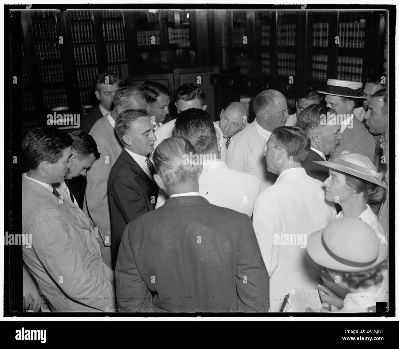 Newsmen stalk senators as Senate Judiciary Committee meeting adjourns. Washington D.C., July 22. Newspapermen stalking members of the Senate Judiciary Committee today as they emerged from the extraordinary session of the Committee. In the photograph, left to right, can be seen the profiles of Senators O'Mahoney, Wyoming; Austin of Vermont; and Burke of Nebraska, 7/22/37 Stock Photo