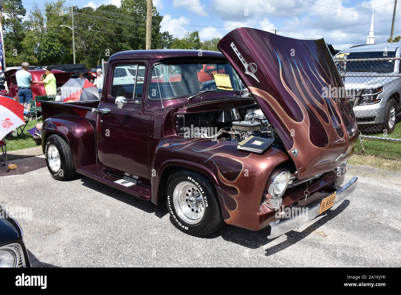 A 1956 Ford Pickup Truck On Display At A Car Show Stock