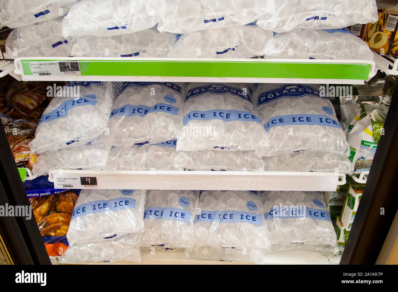 Packets of ice for sale in a large industrial freezer. Stock Photo