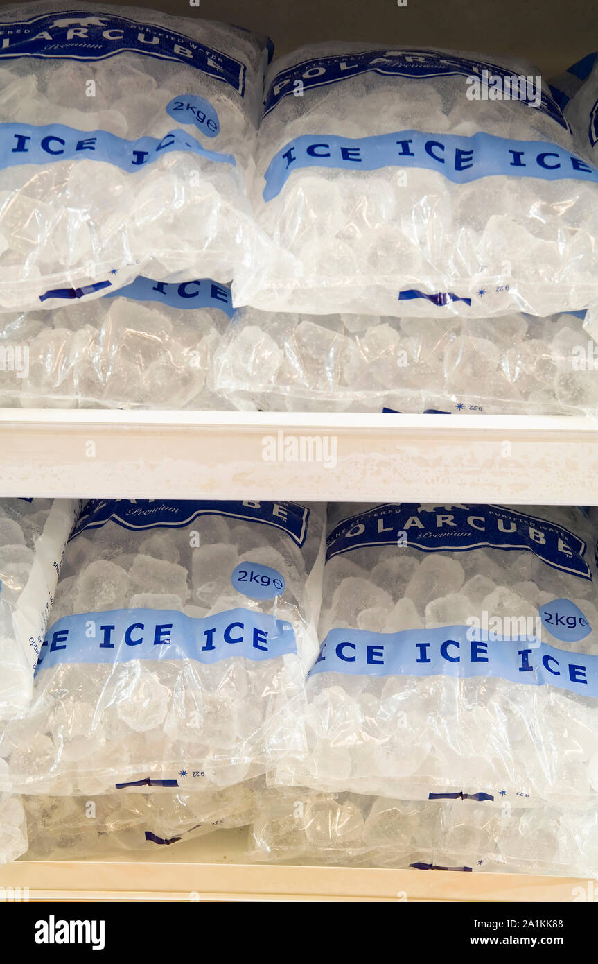 Packets of ice for sale in a large industrial freezer. Stock Photo