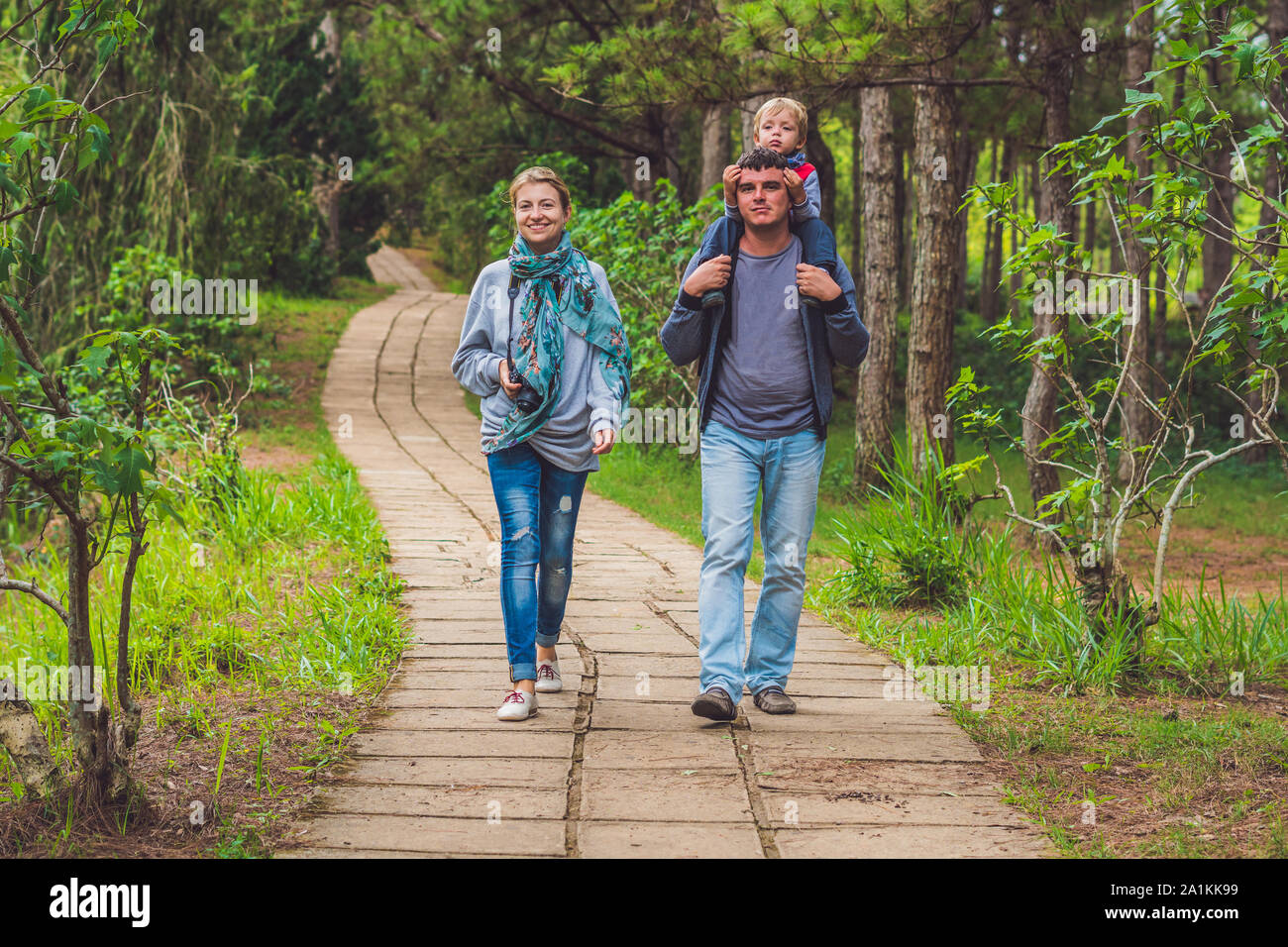 Family, mother, father and son, walking the park path Stock Photo