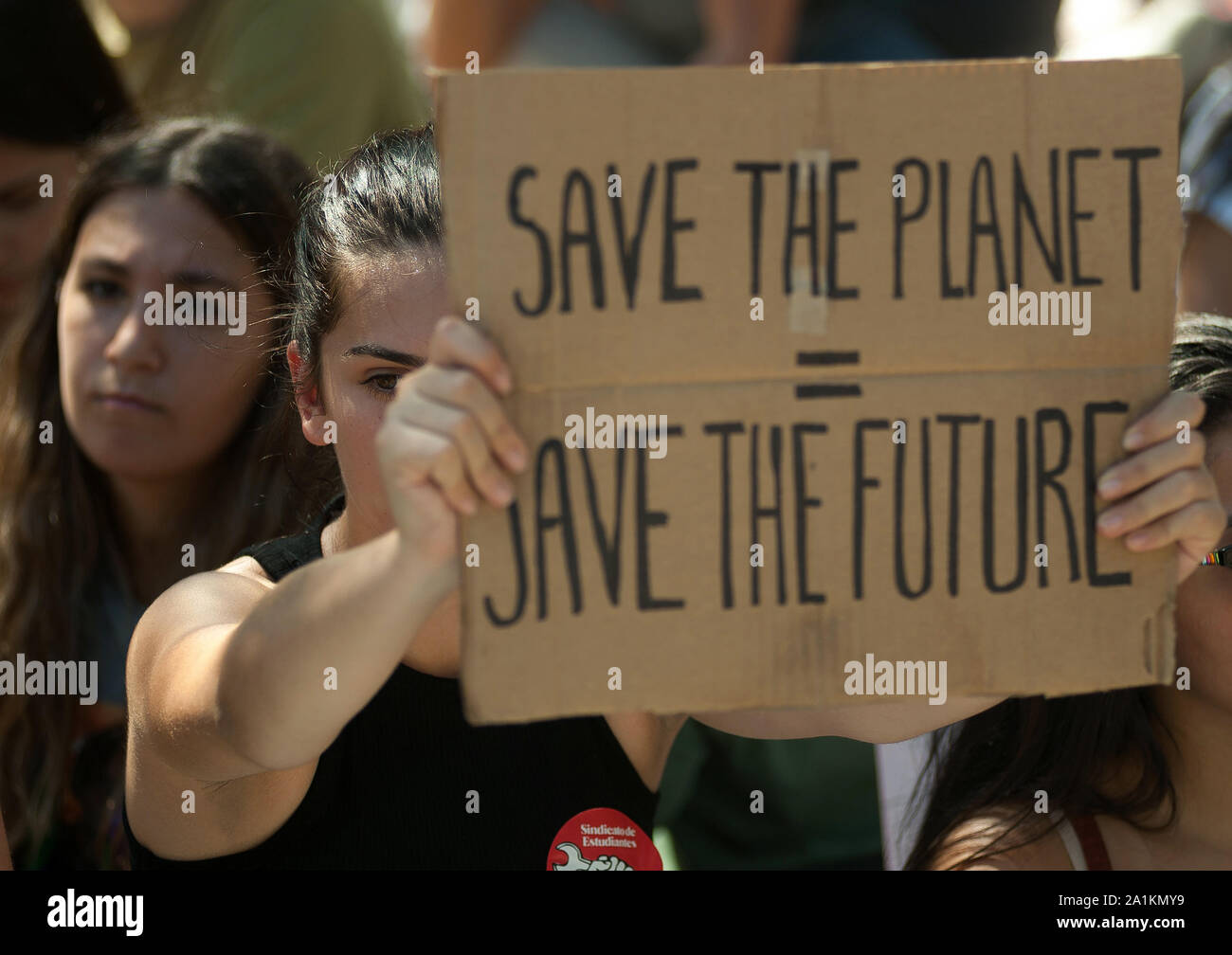 Save The Future Sign A student holds a placard saying