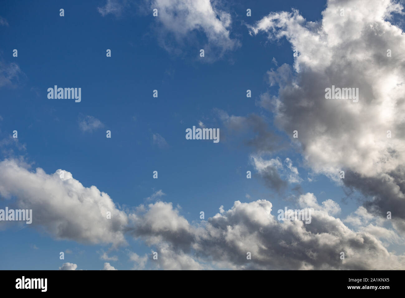 Blue sky with white and dark clouds background. Nature backdrop Stock Photo