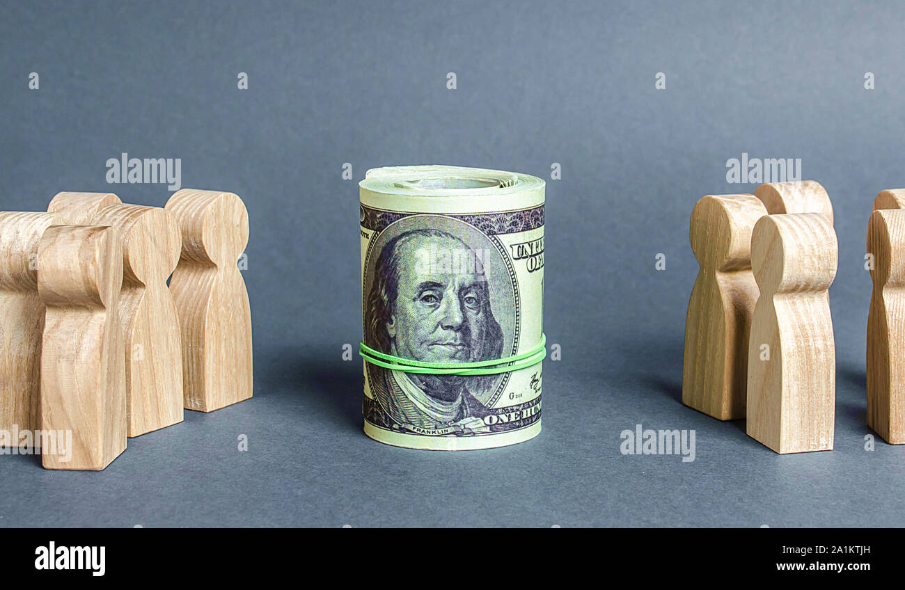 Two groups of people are divided by a bundle roll dollars. The cult of money, capitalism. Financial instruments and education. Decent salary wages. In Stock Photo