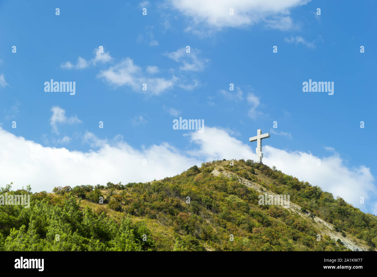 Gelendzhik, Krasnodar region, Russia, September 11. Orthodox worship cross on the hill of Caucasian mountains with chapel in foundation. Day time. Stock Photo