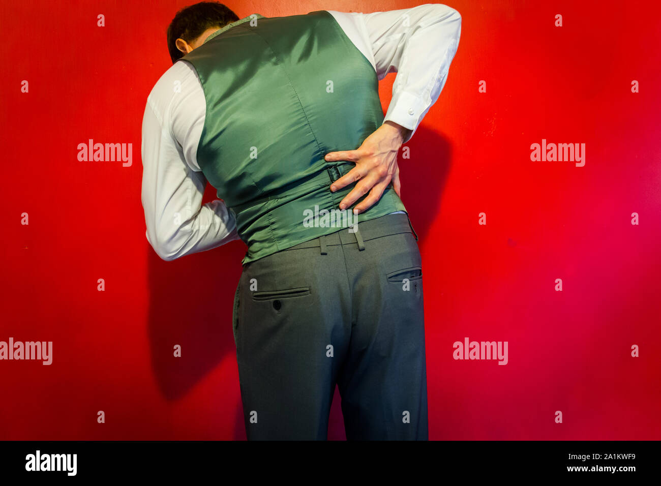 Man Holding His Back in Pain Stock Photo