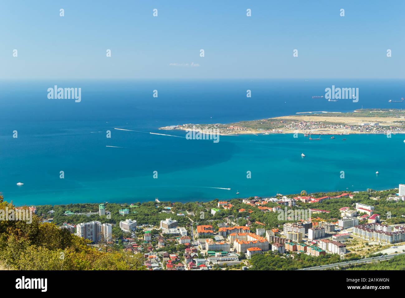 Scenic view of Gelendzhik city district and sea bay and water of Black sea. Sunny day. Vacation on resort. Ships and boats. Stock Photo