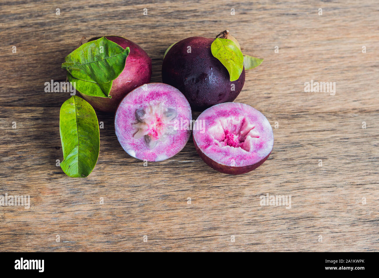 fresh Chrysophyllum cainito fruits on wood background Stock Photo