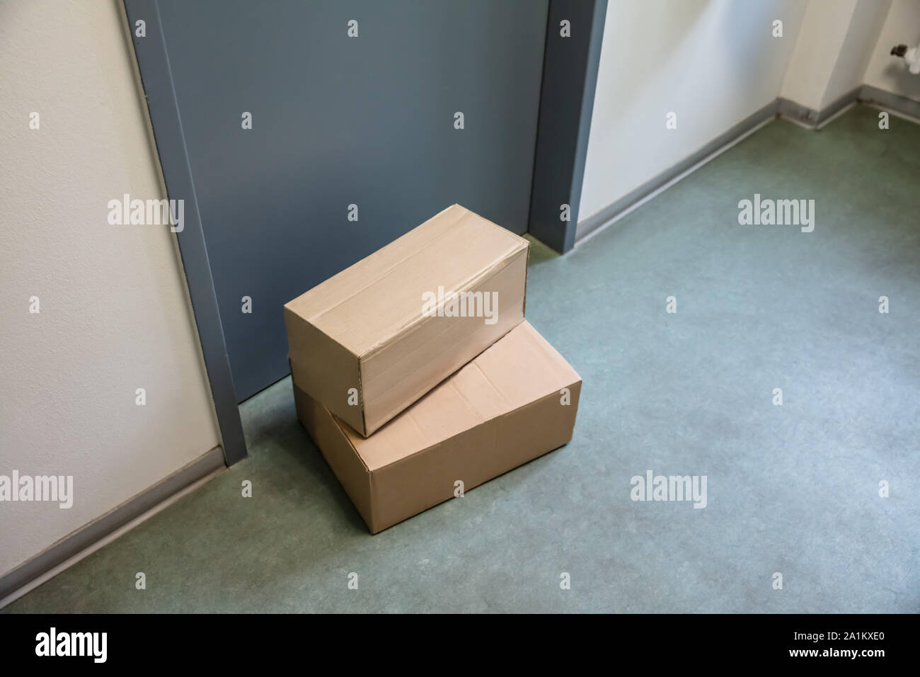 Close-up Of Cardboard Parcel Boxes Delivered Outside Front Door Stock Photo