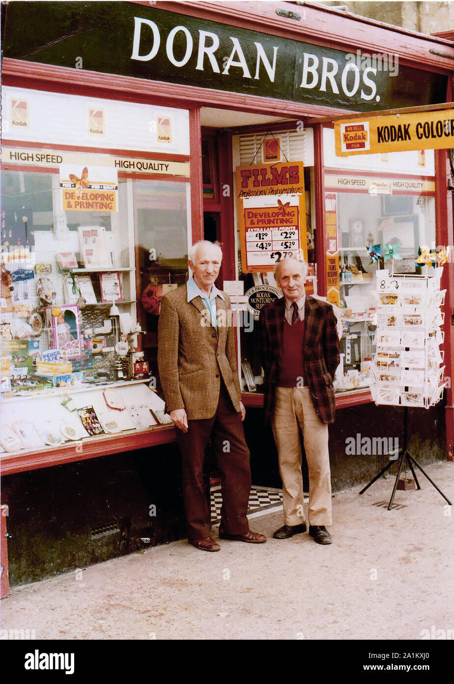 A portrait of Doran Brothers (Terry & Eric)  photographers of    Marine Parade, Whitby, Yorkshire, UK. The renowned  brothers who were well known   in Yorkshire as commercial,  news, wedding, and general photographers are  pictured in front of their shop just before they retired (1987). Their business ran from 1900-1987 Stock Photo