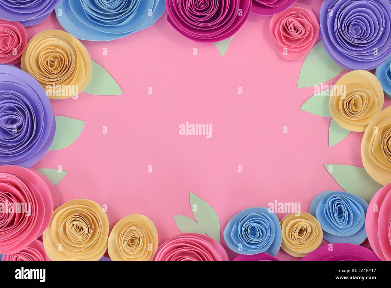 Pastel colored paper craft rose flat lay background with flowers