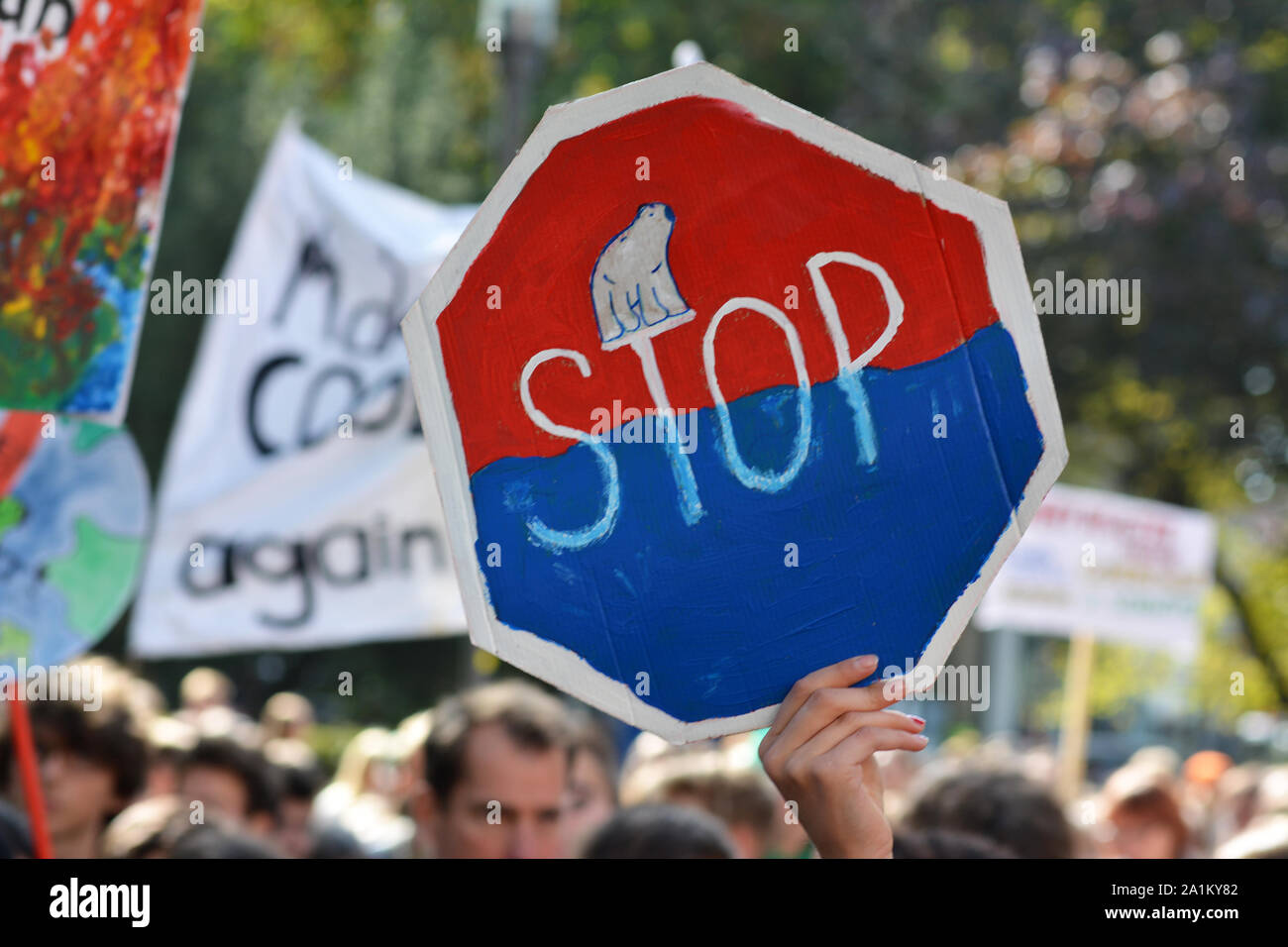 Germany, Protest sign resembling a stop traffic sign with polar bear on melting ice held up during Global Climate Strike and Fridays for future Stock Photo