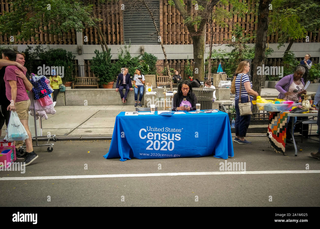 Worker at a Census 2020 information table at a street fair in New York on Saturday, September 14, 2019. The census is a count of everyone living in the United States, citizens and non-citizens. By law it is conducted every 10 years and the information is used to reapportion congressional districts as well as affecting the distribution of government funds.  (© Richard B. Levine) Stock Photo