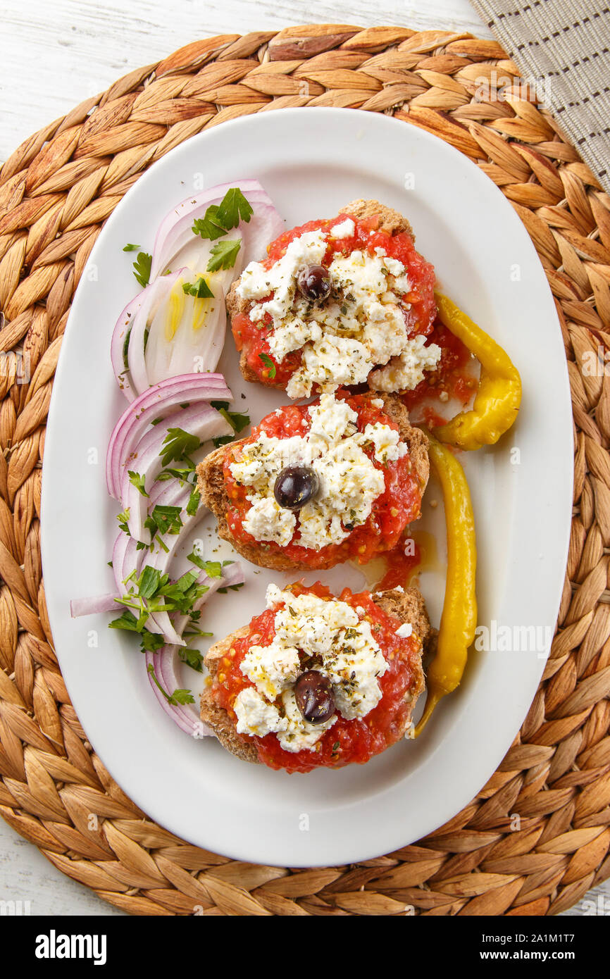 Ntakos, rusk with tomato & cheese, Greek appetizers, Meze Stock Photo