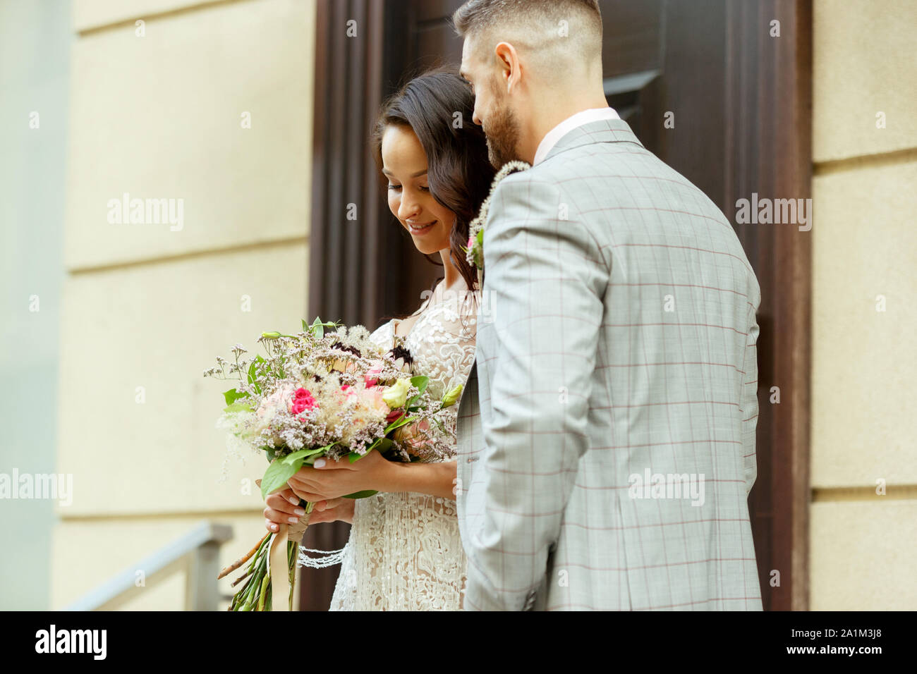 Caucasian romantic young couple celebrating their marriage in city
