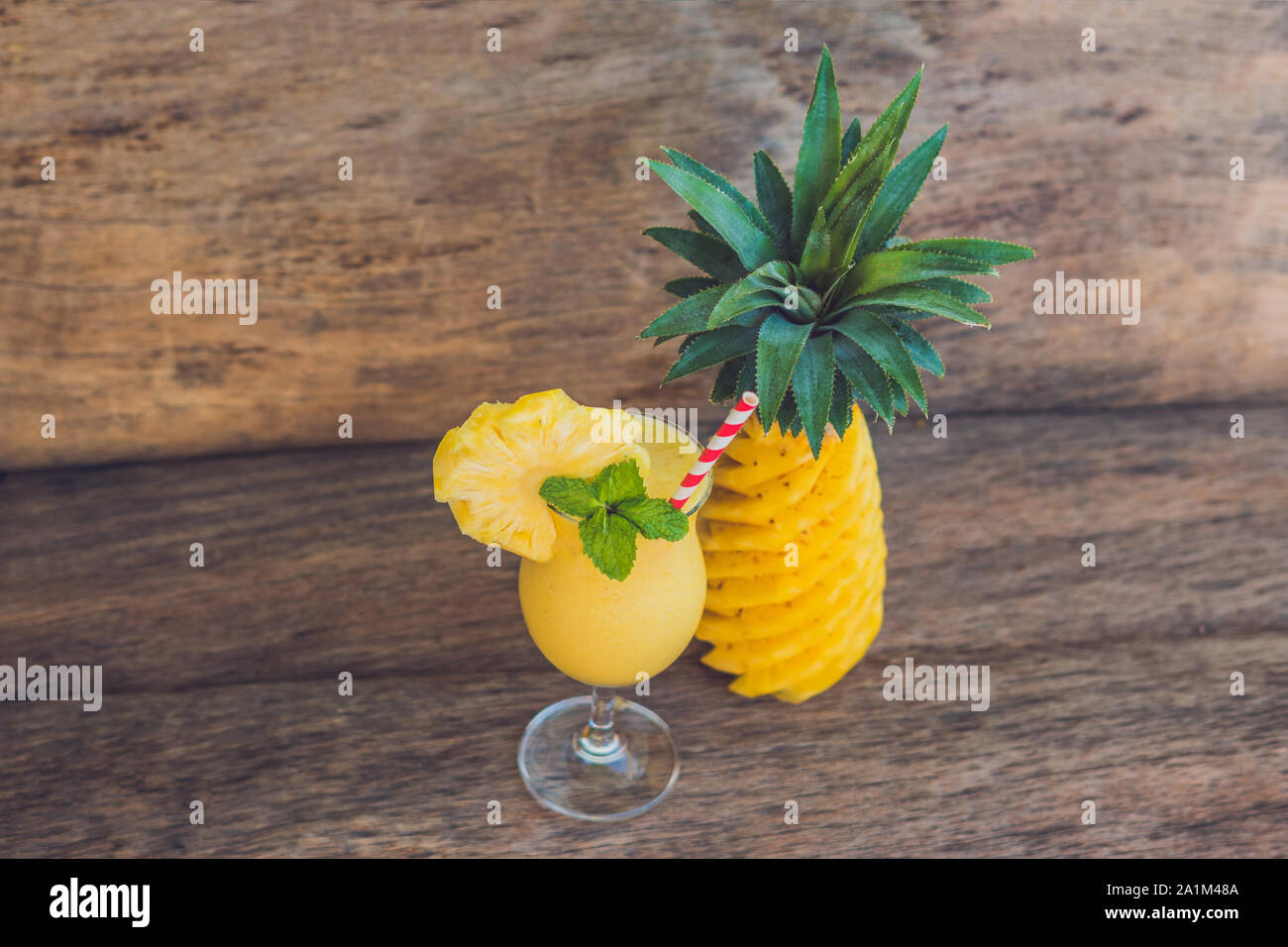 Pineapple and pineapple smoothies on an old wooden background Stock Photo