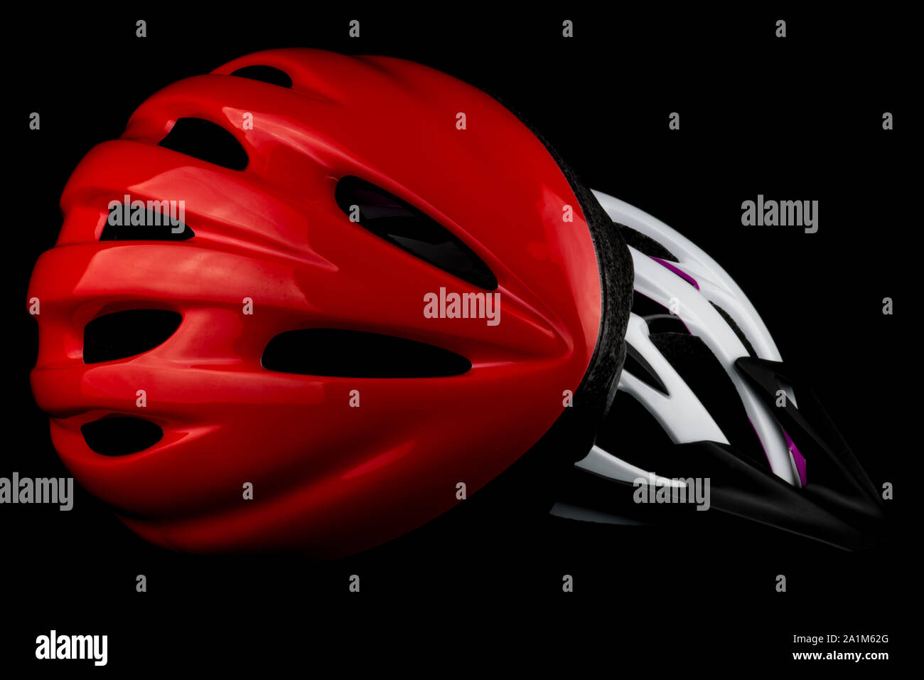 Cycle safety helmets isolated on a black background Stock Photo Alamy