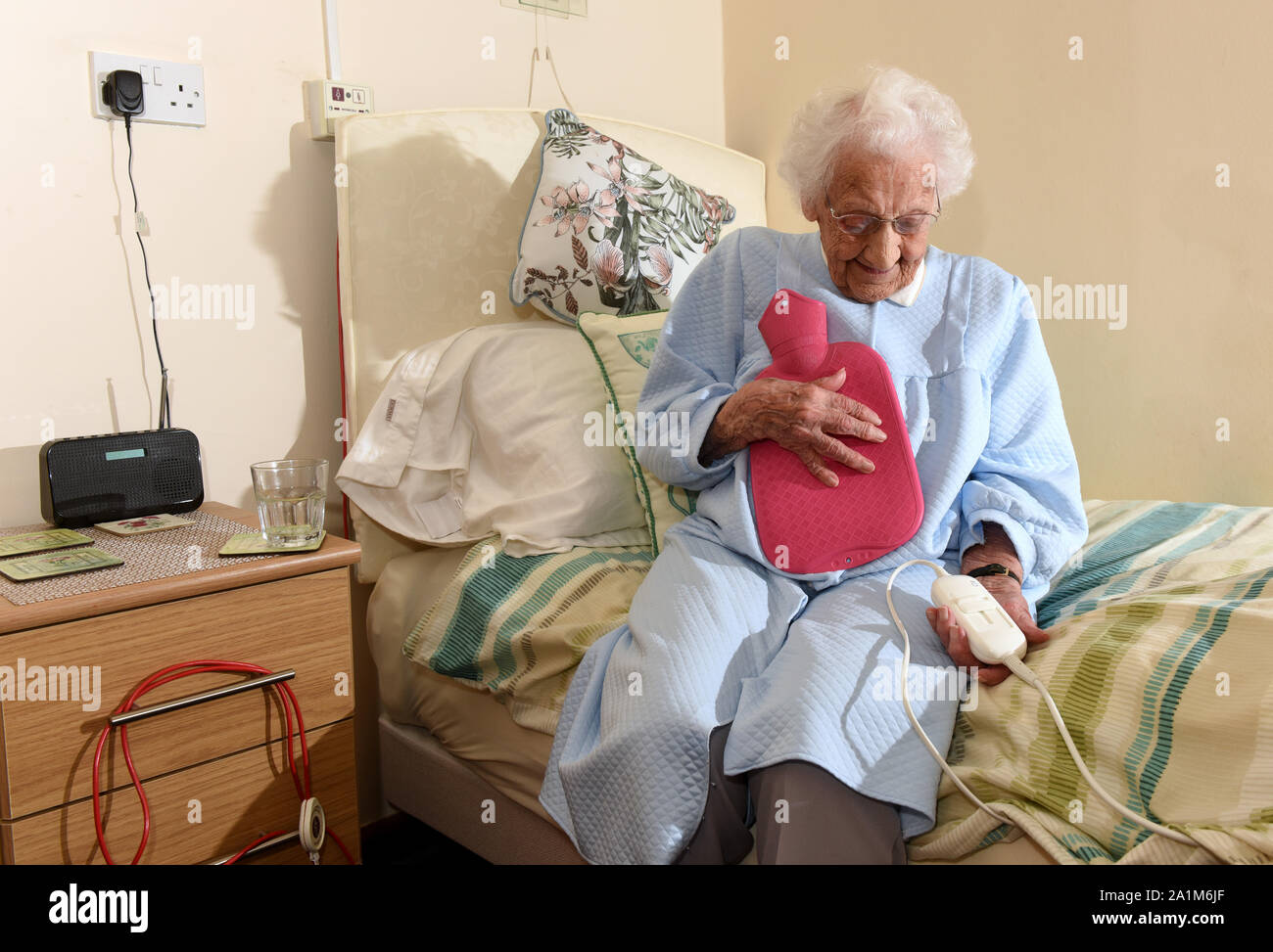 Elderly lady going to bed with an electric blanket and hot water bottle  Britain Uk Stock Photo - Alamy