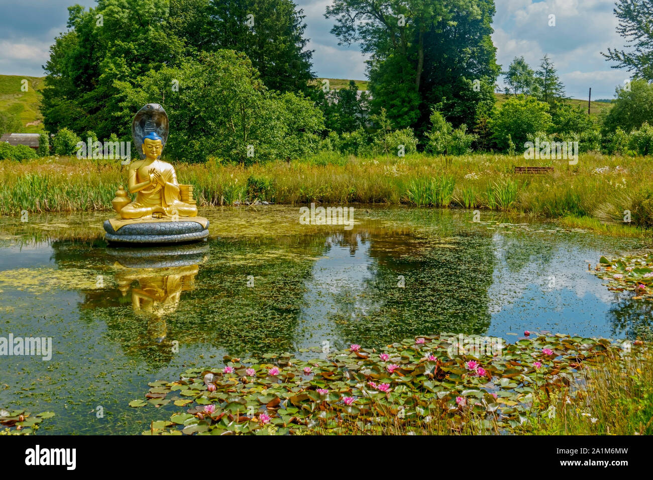Statue of the Buddhist god Nagarjuna in a pond at the Kagyu Samye Ling Monastery and Tibetan Centre in Eskdalemuir, Dumfries and Galloway, Scotland. Stock Photo