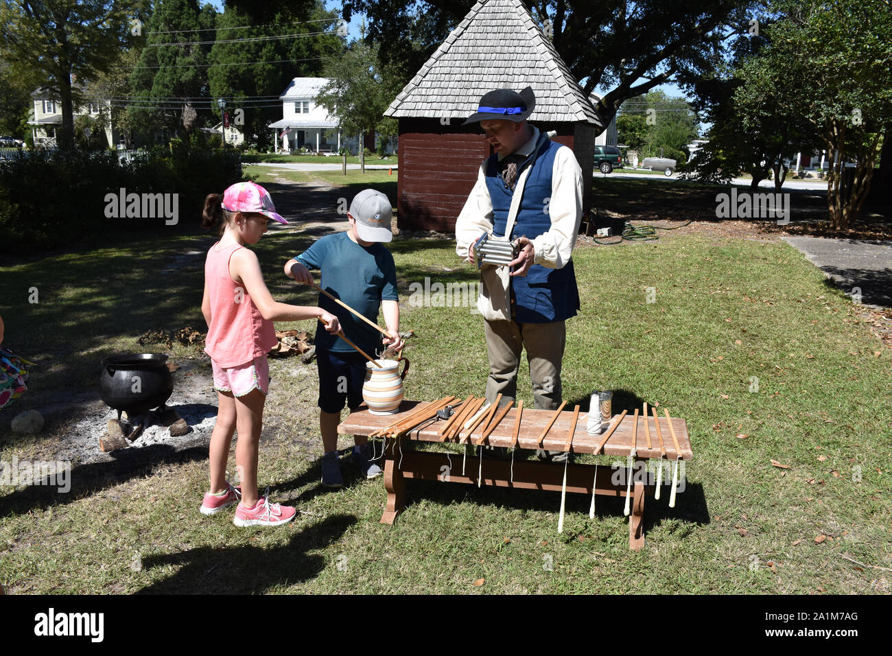 A demonstration of how candles were made in Colonial times Stock Photo