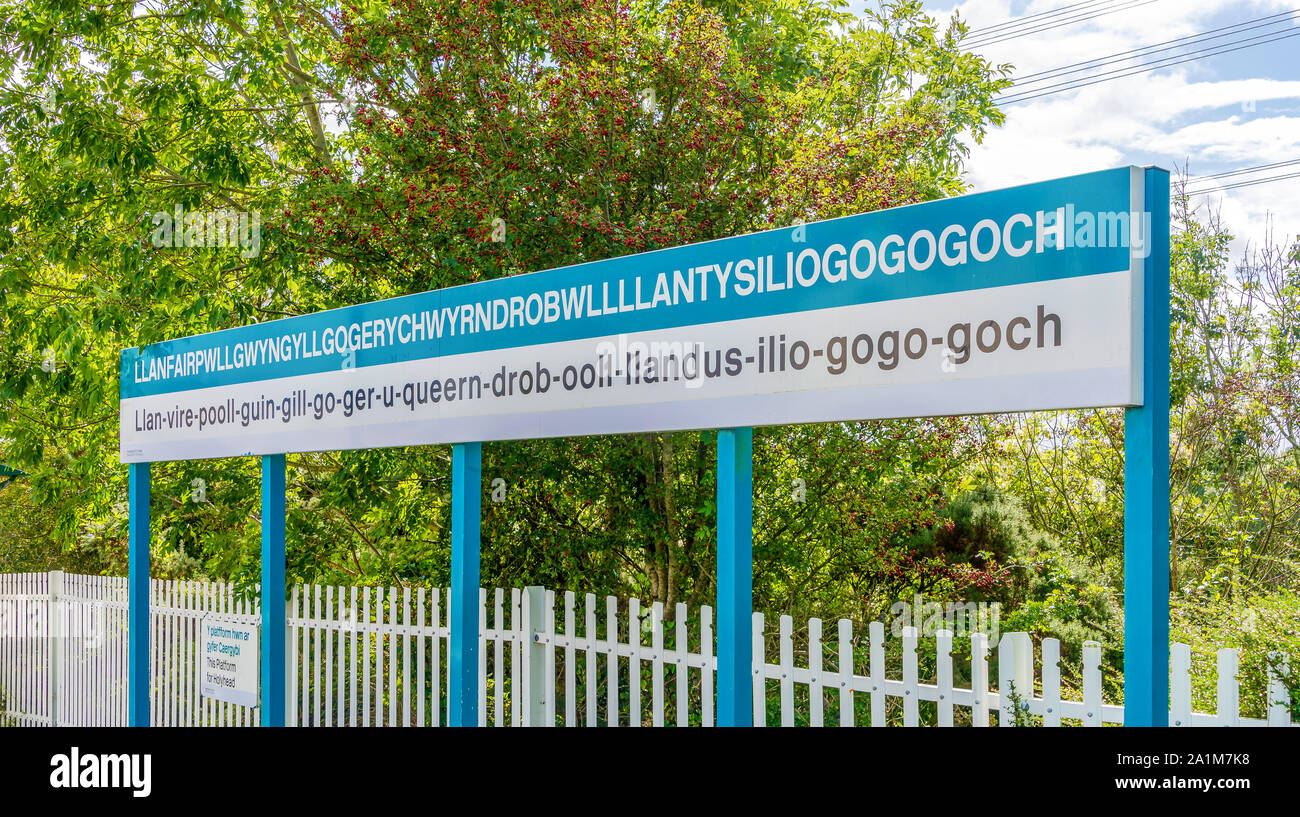 Station sign at Llanfairpwllgwyngyll in North Wales.  The longest place name in the UK spelt out in full with the pronunciation below. Stock Photo
