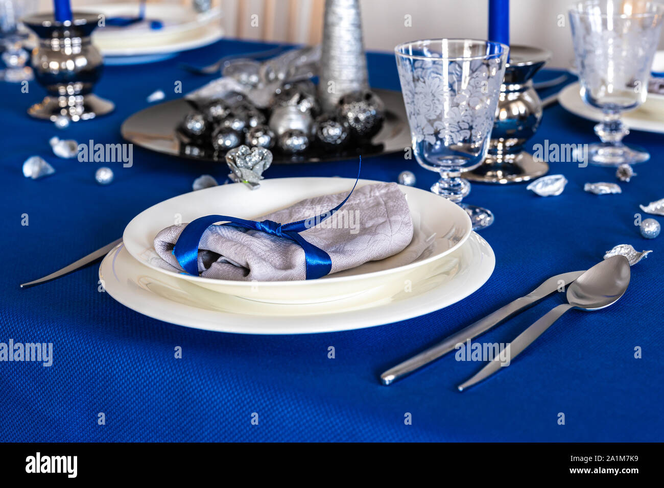 A plate in a blue christmas table setting Stock Photo Alamy