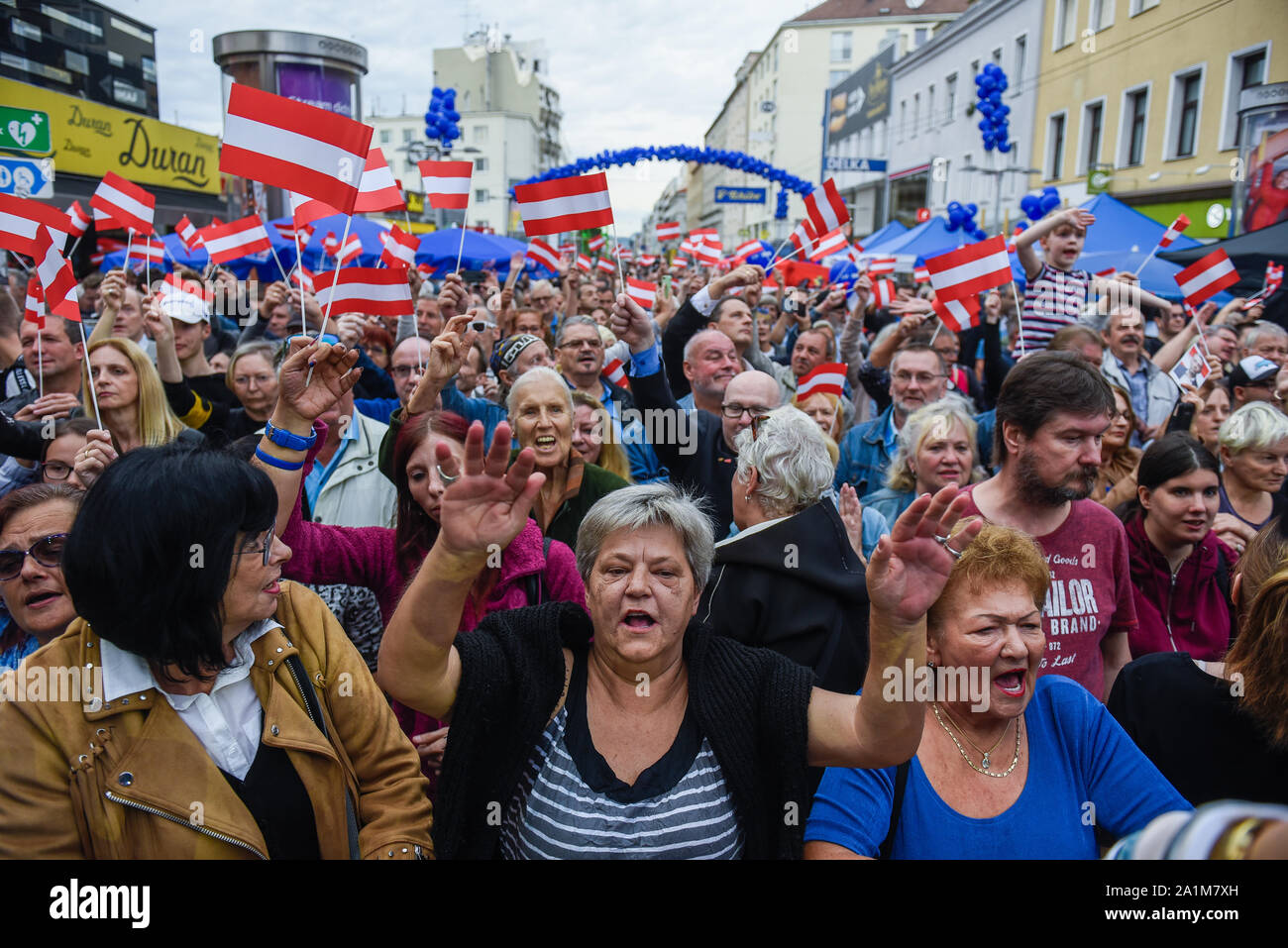 Supporters with Austrian flags applauding Norbert Hofer who is speaking, during a campaign event ahead of Sunday's snap parliamentary elections.On September 29, 2019 parliamentary elections will take place as a result of a hidden-camera footage where OeVP's coalition partner, the far-right Freedom Party (FPOe) was caught up in a corruption scandal and brought the government down. Stock Photo