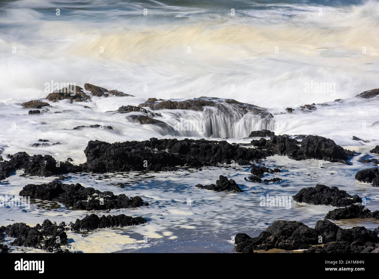 Thor's Well and incoming surf, Cape Perpetua, Oregon, USA Stock Photo
