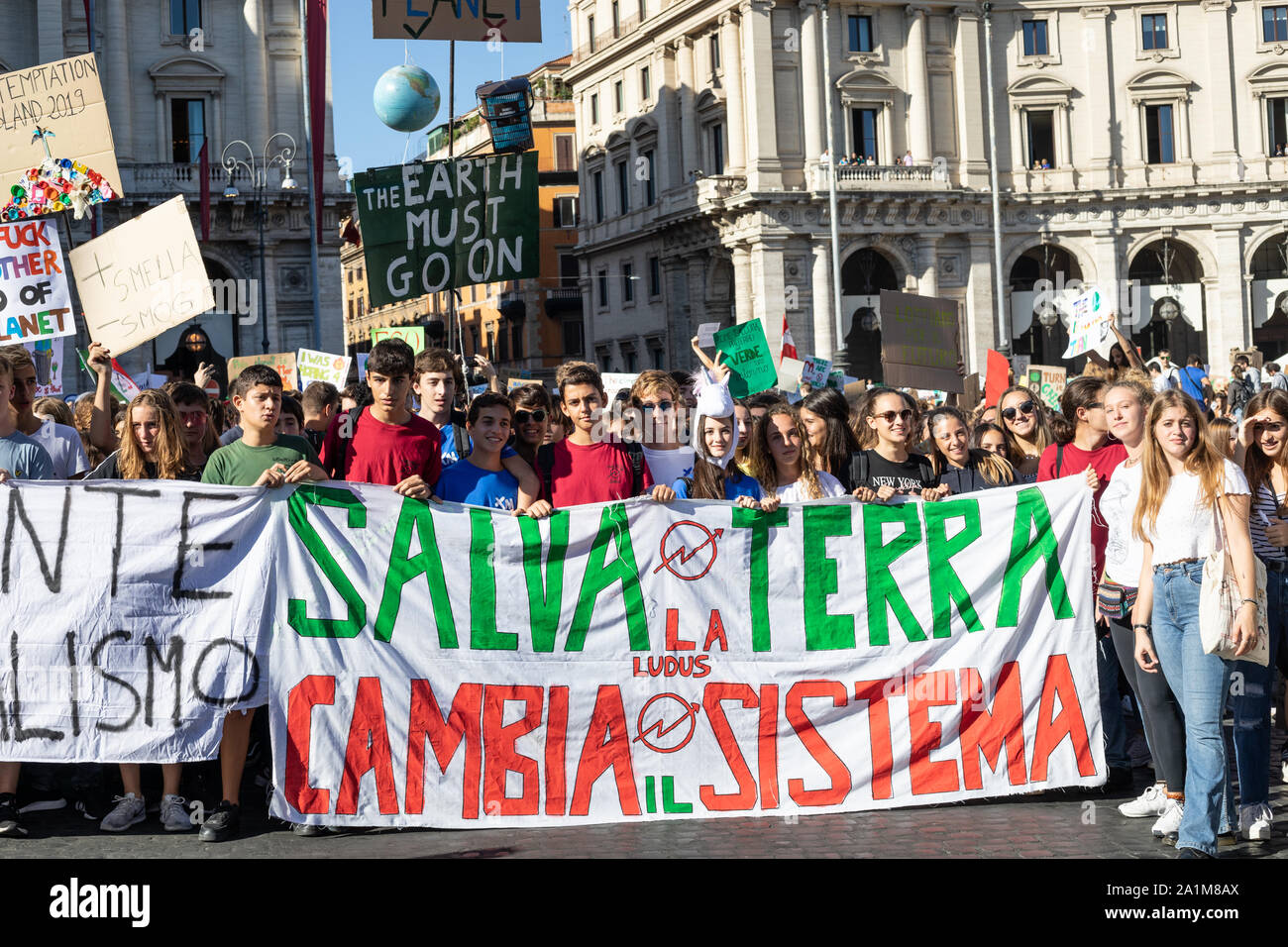 Students pose behind a huge banner saying, save the planet changes the system, during the protest.Friday for the future: an international demonstration of the earth that with great student participation started from Piazza della Repubblica to Piazza Madonna di Loreto (Piazza Venezia) in Rome. Stock Photo