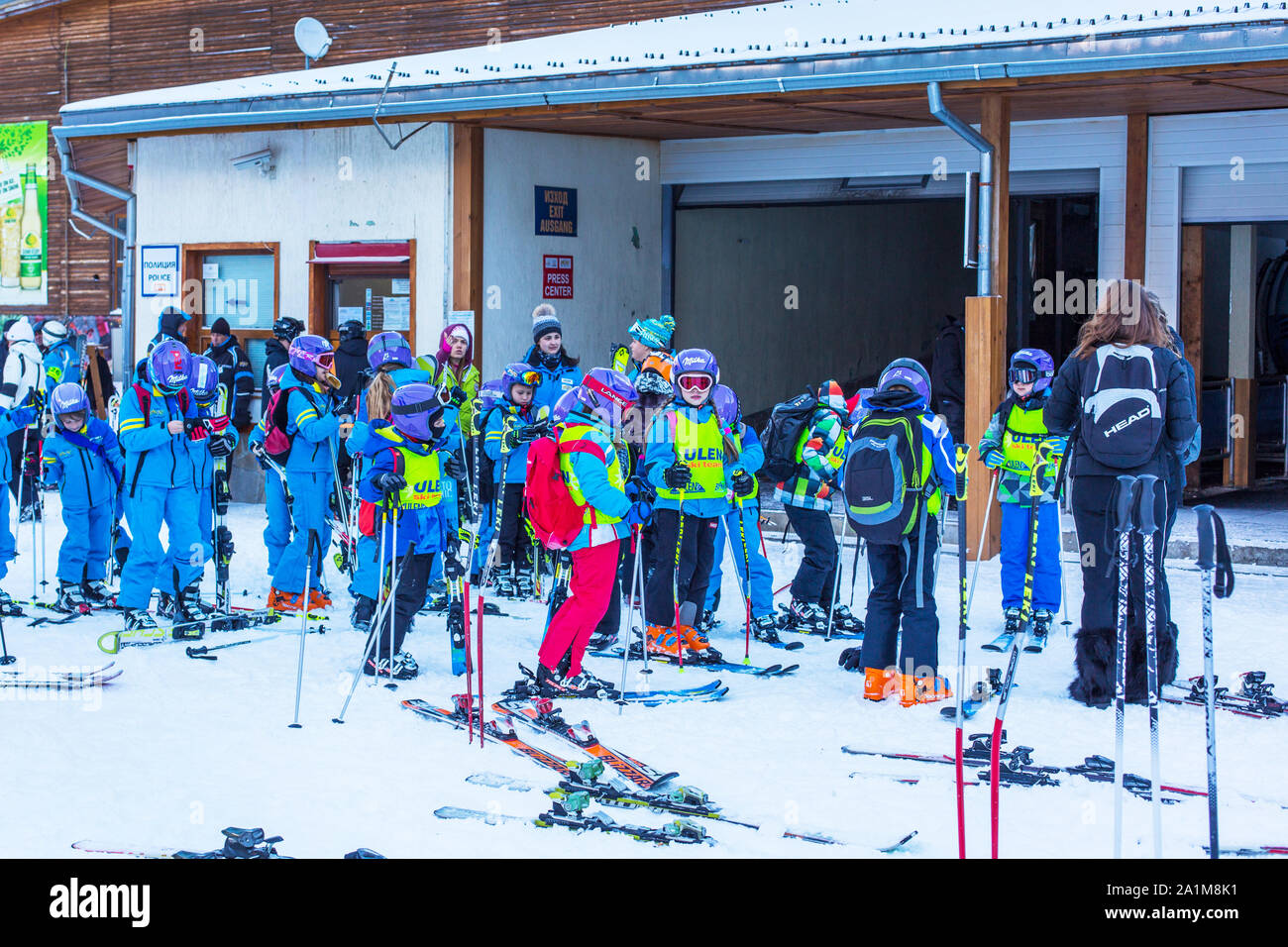 Bansko, Bulgaria - December, 12, 2015: Many young skiers preparing to ski in Bansko, Bulgaria Stock Photo