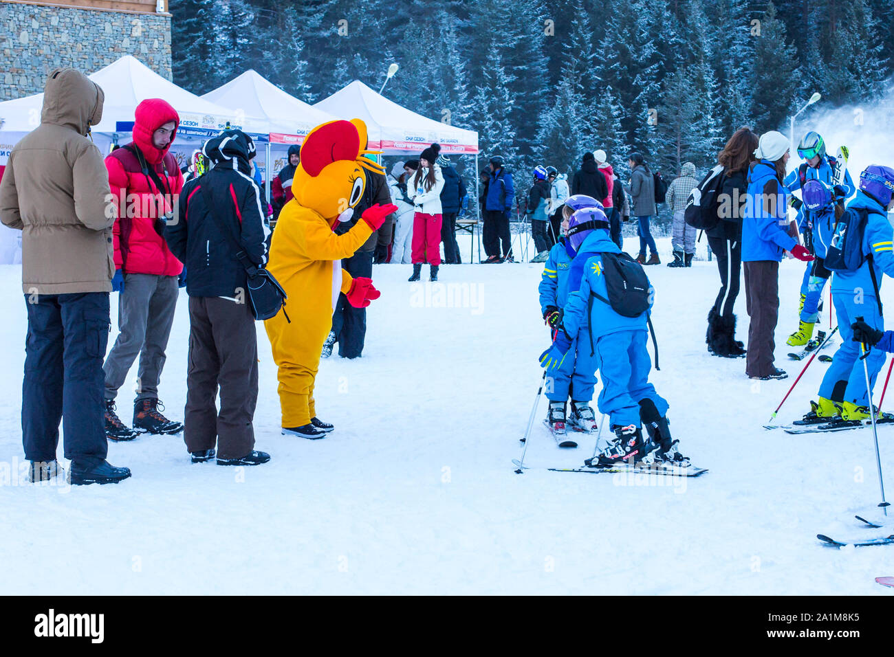 Bansko, Bulgaria - December, 12, 2015: Young skiers talking to Mouse in Costume at ski resort Stock Photo