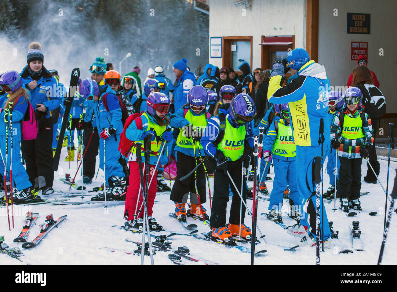 Bansko, Bulgaria - December, 12, 2015: Many young skiers preparing to ski in Bansko, Bulgaria Stock Photo