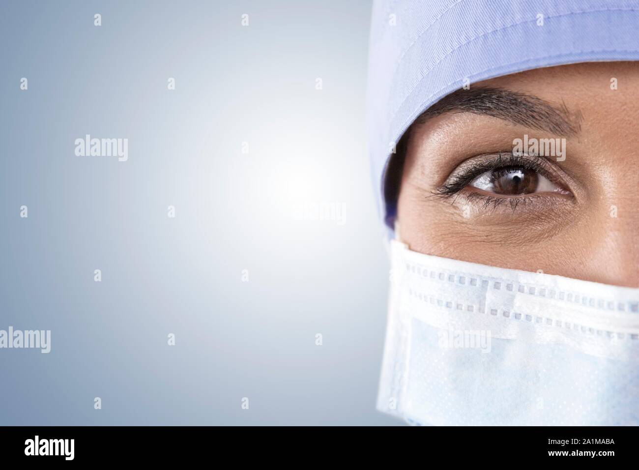 Female surgeon wearing cap and surgical mask Stock Photo - Alamy