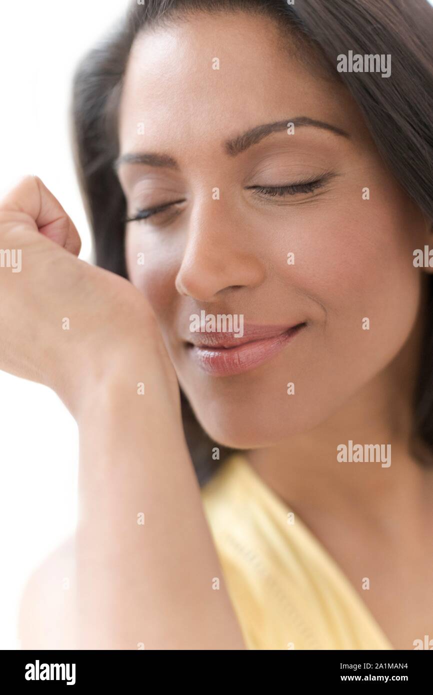 Woman smelling perfume on wrist. Stock Photo