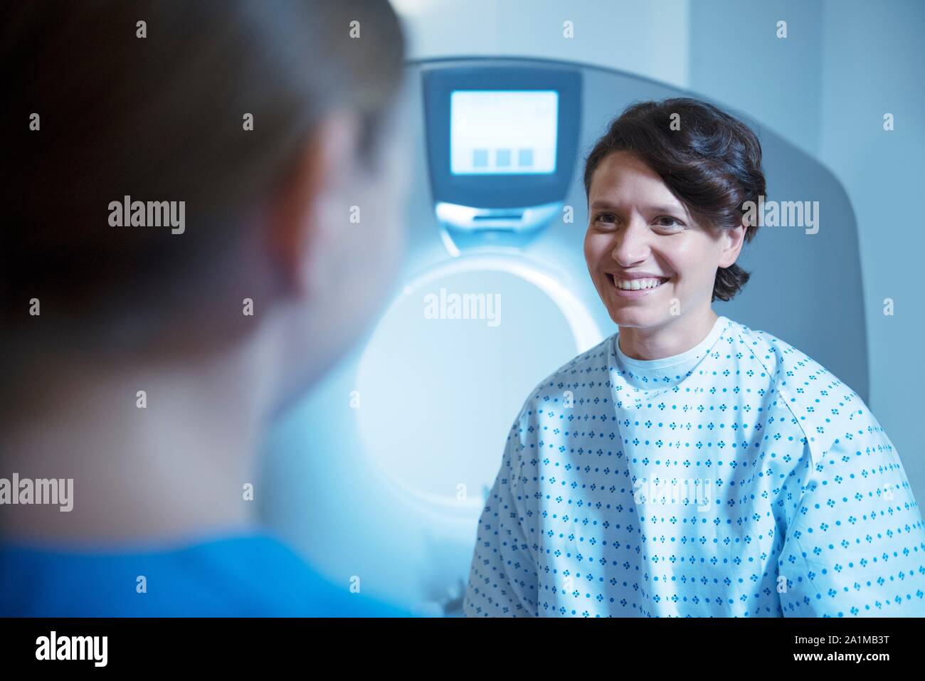 Radiographer preparing patient for computed tomography (CT) scan. Stock Photo