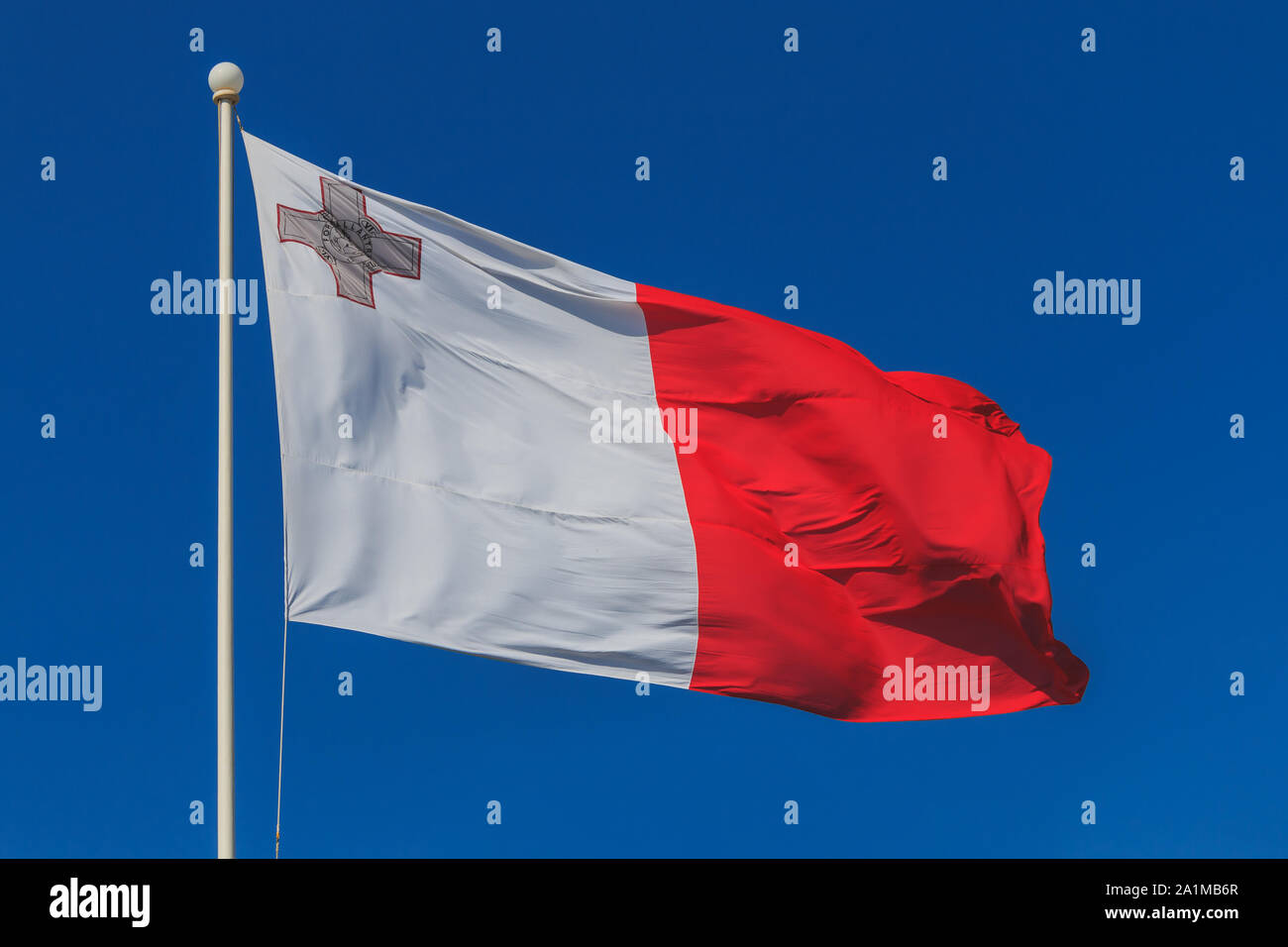 Malta national flag is waving in deep blue sky background Stock Photo