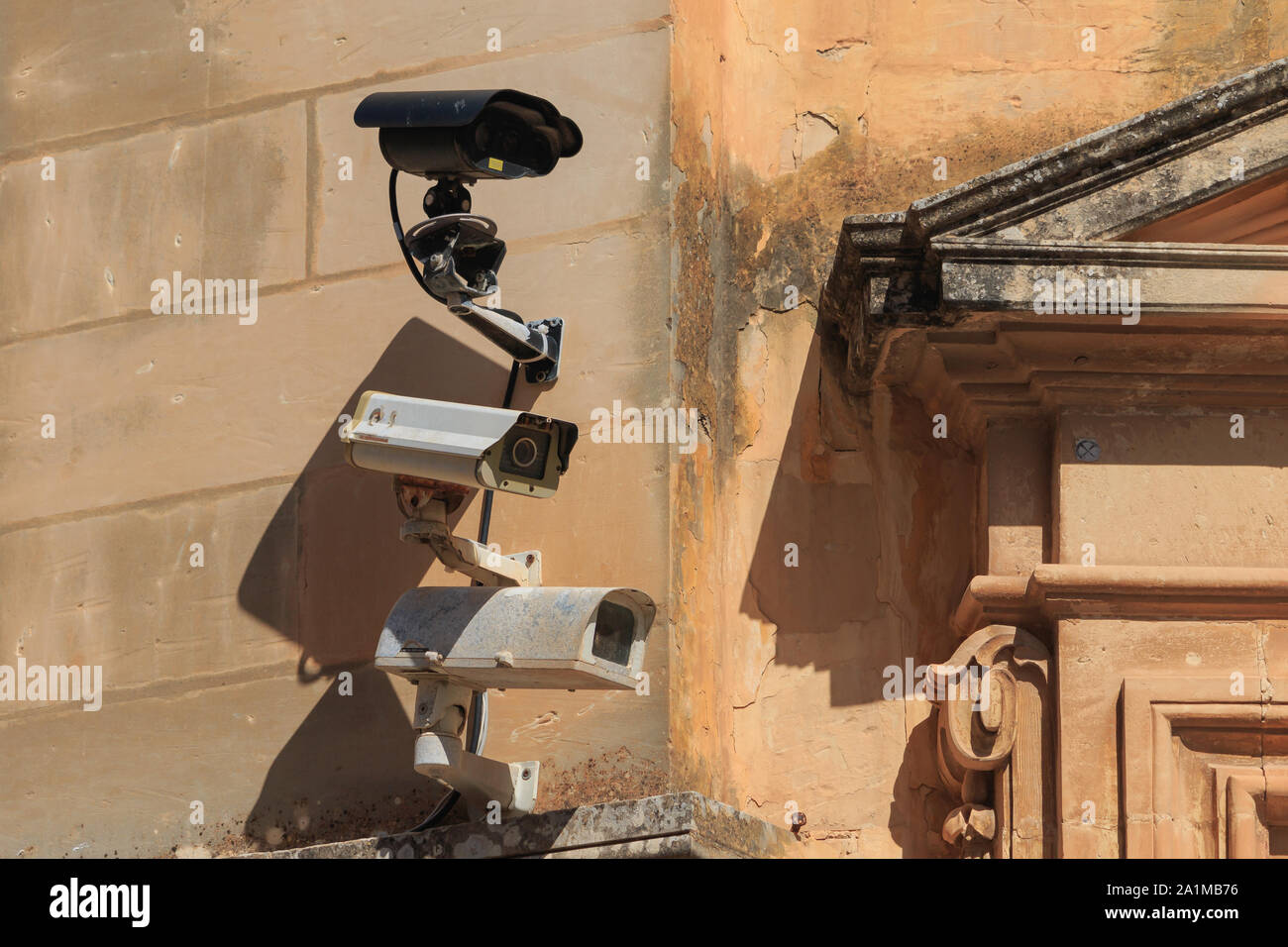 Three surveillance cameras on old wall in Mdina city, Malta Stock Photo