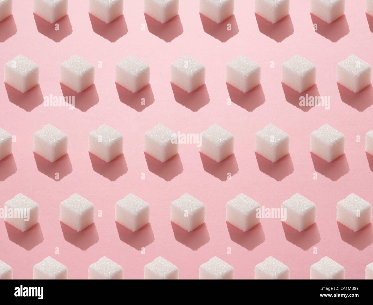 Sugar cubes on pink background. Stock Photo