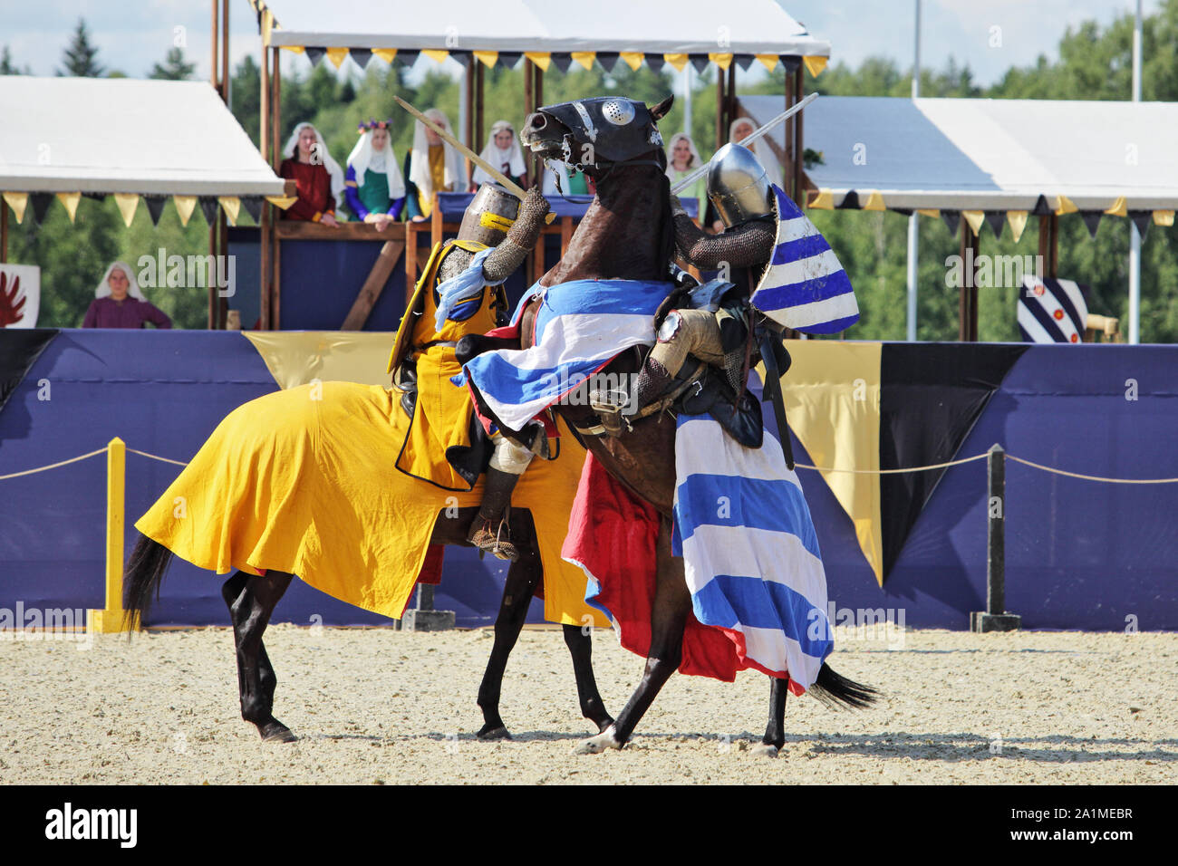 Mounted knights wearing full plate armour sword fighting at  annual medieval tournament 'Ivanovo Pole 2019' Stock Photo