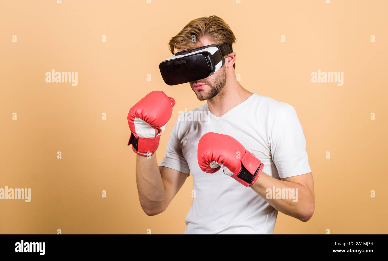 Augmented 3D world. Cyber sportsman boxing gloves. Man play game in VR glasses. Cyber sport concept. Man boxer virtual reality headset simulation